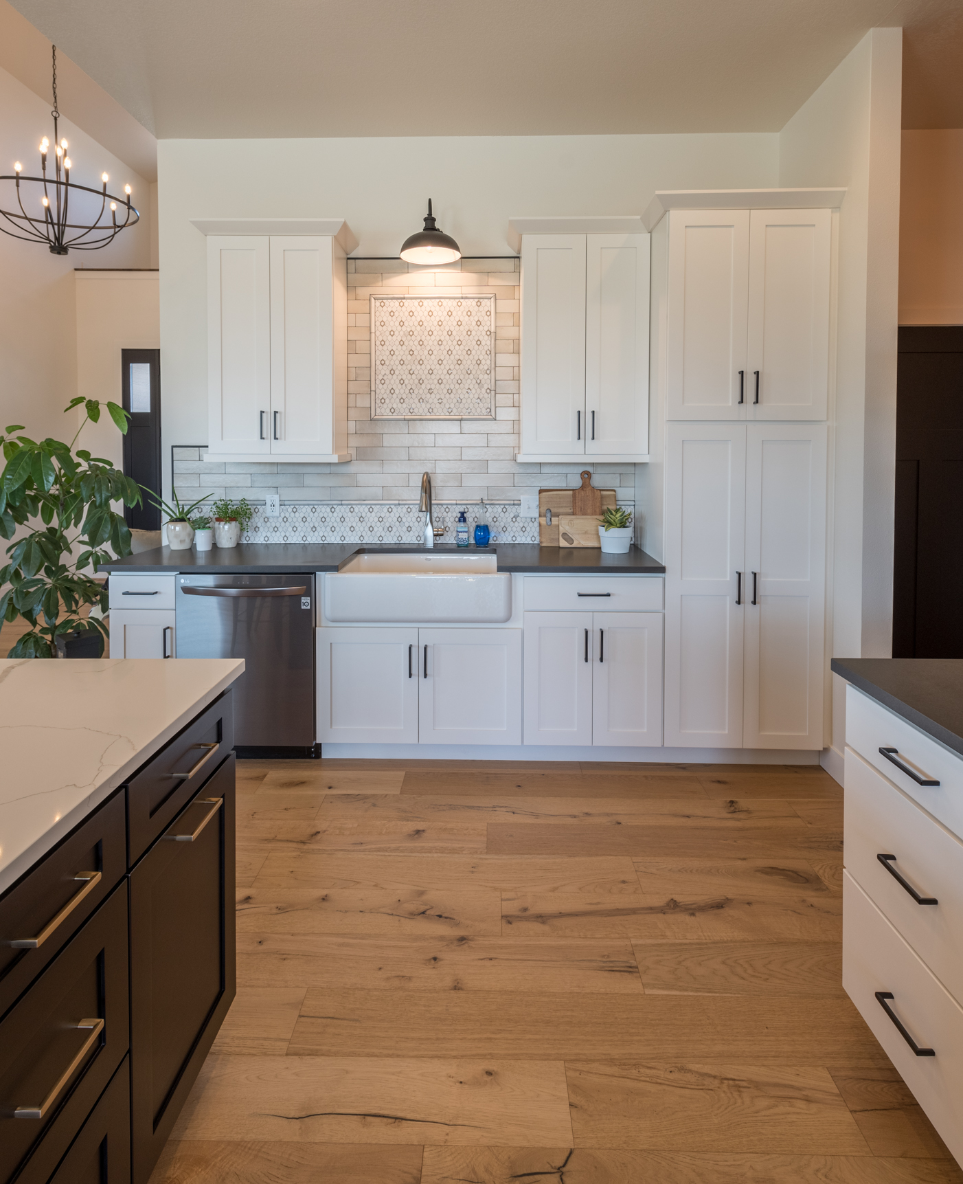 White kitchen cabinets, white & gray countertops with intricate patterned backsplashes